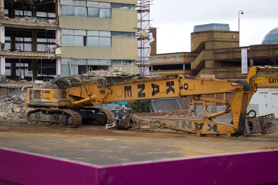 Excavator demolishing a building.